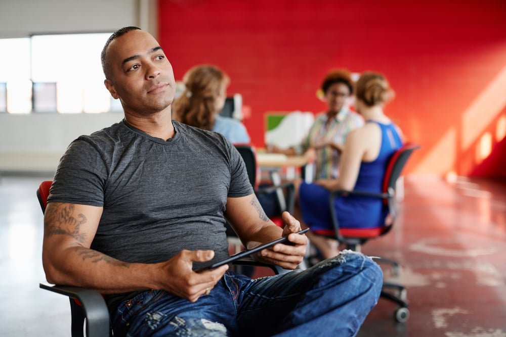 Facilities Manager managing his office space on his tablet.