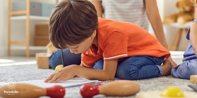 young child drawing on the floor