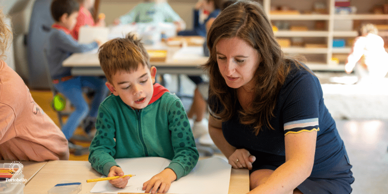 A teacher working one to one in school with a young child