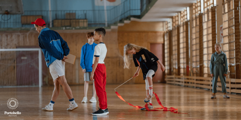 Physical Education PE Teacher in a gym with young students