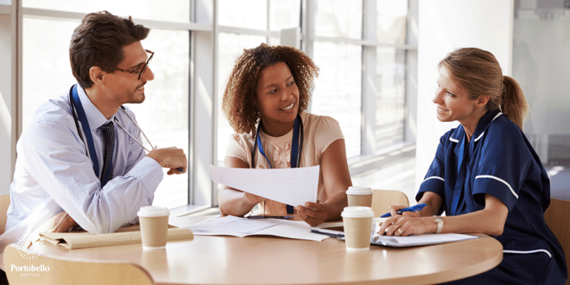 healthcare professionals sitting around a table talking