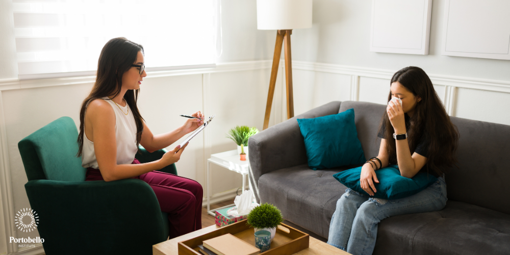 a young girl during a counselling session with a therapist in a modern room
