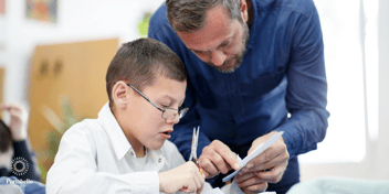 An inclusive education teacher helping a young student