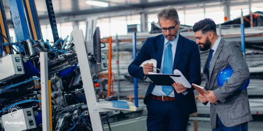 two facilities managers looking at an ipad near machinery