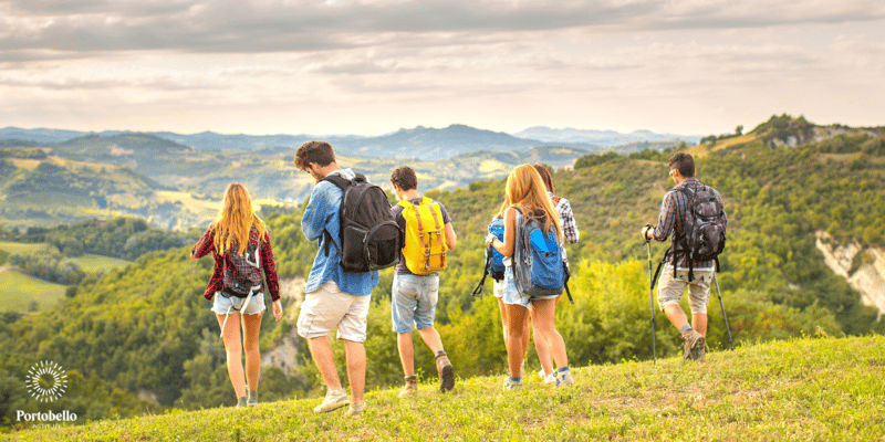 group of people hiking in green hills