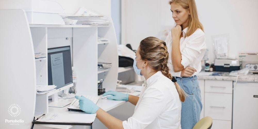 two women working in healthcare looking at a computer