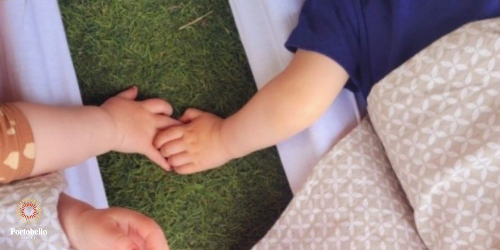 Babies holding hands while sleeping