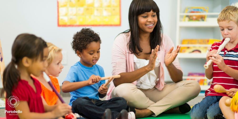 An early childhood educator sitting on the floor with preschool children playing with musical instruments