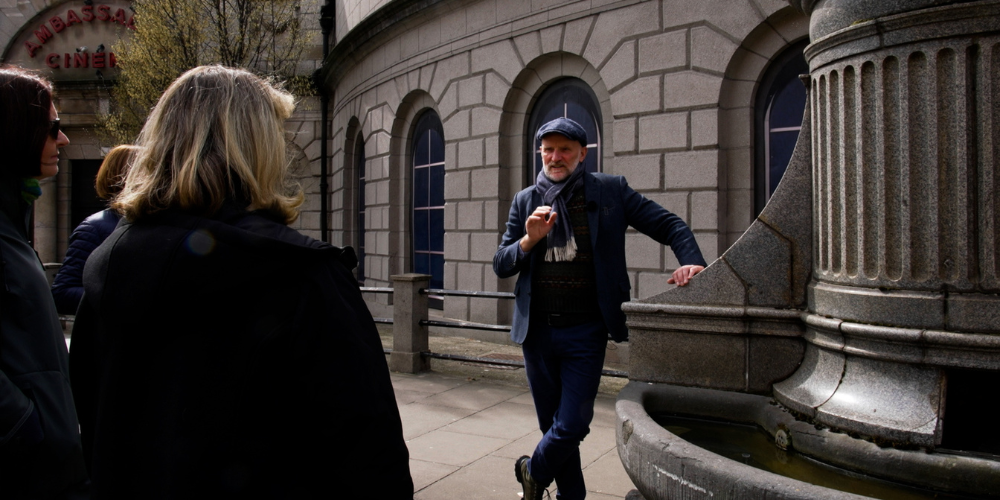 tour guide talking beside a monument