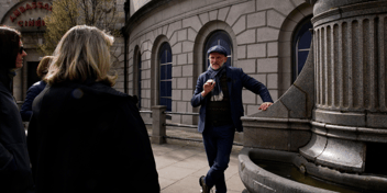 tour guide talking beside a monument