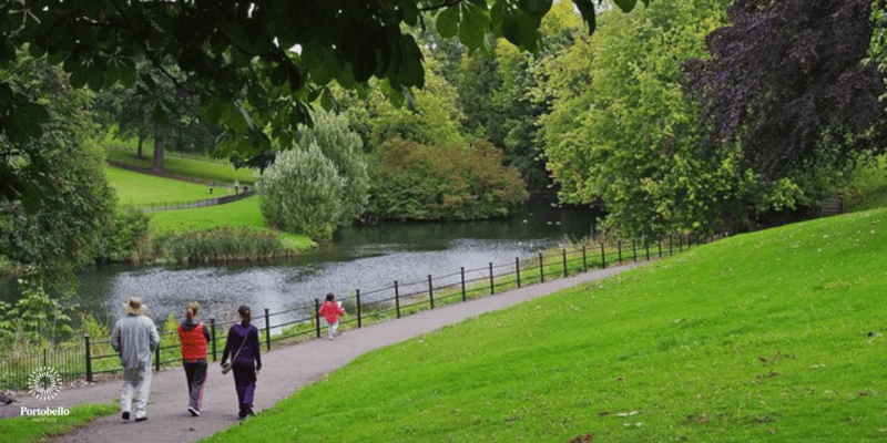 walking on a path beside a lake in Phoenix Park Dublin Ireland