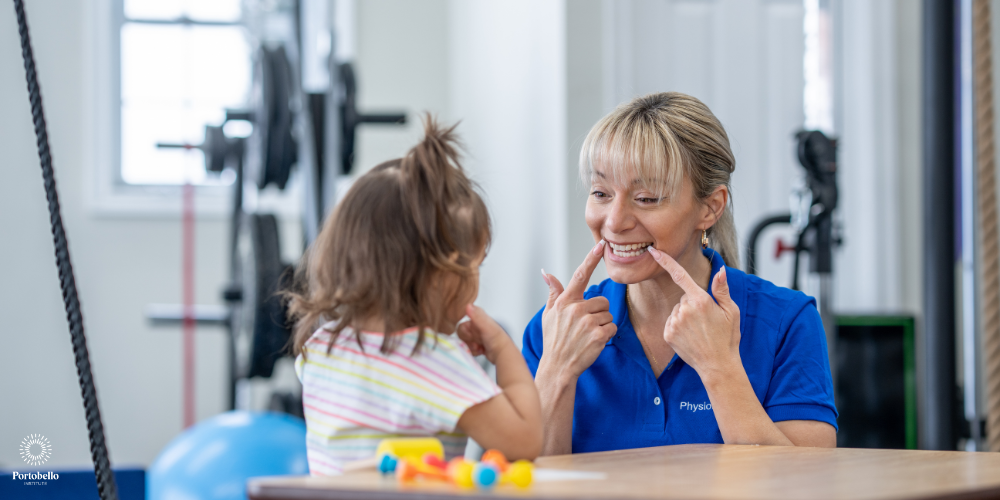 a speech therapist working with a small child in a clinical setting