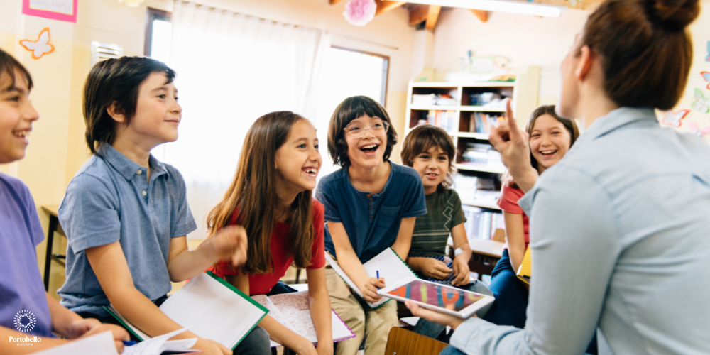 a teacher in a classroom with a group of children smiling and looking up at her