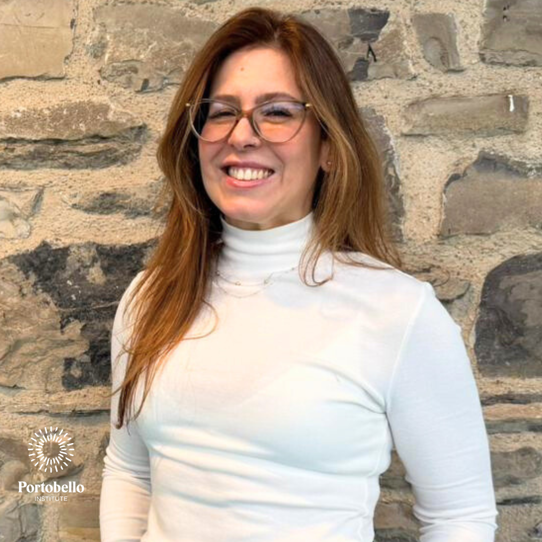 Woman smiling in front of wall