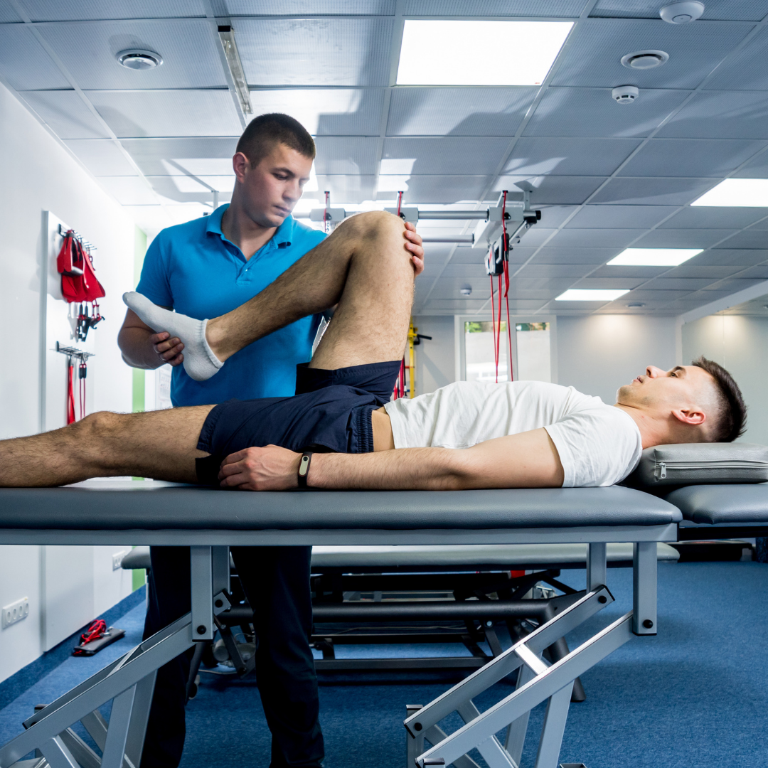 A sports therapist assesses an individual's leg