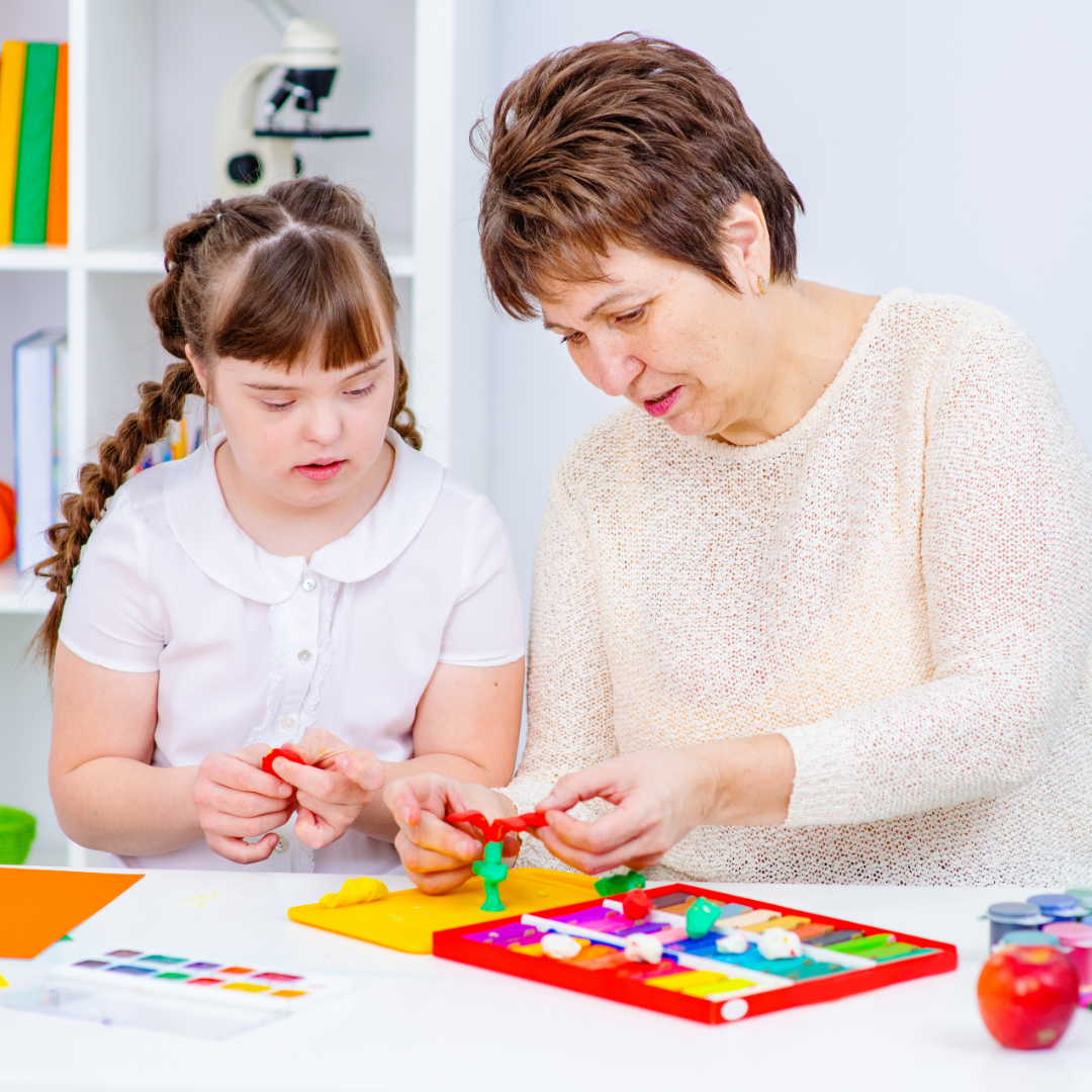 Special needs assistant supporting a young girl