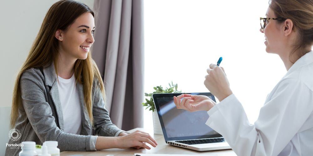 A woman talking to a healthcare professional, smiling