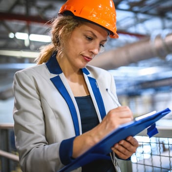 Facilities manager with a clipboard at work