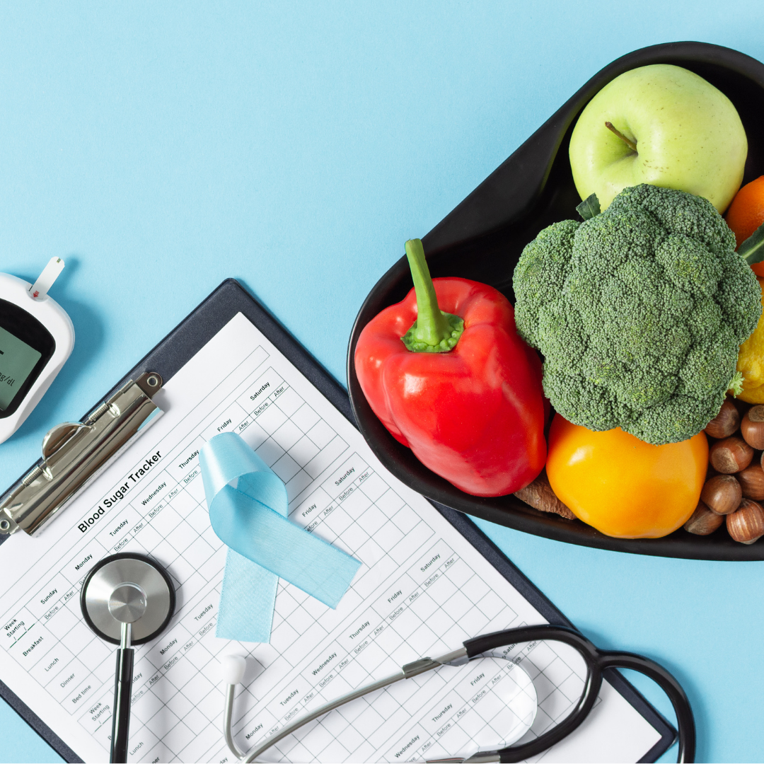 A dietitian's paperwork, healthcare equipment and a bowl of fruit, vegetables, and nuts