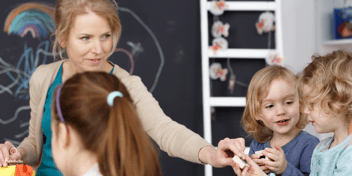 A teacher with young children in a classroom