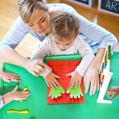 sen teacher teaching a young student about numbers